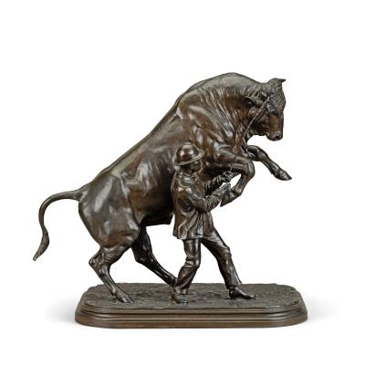 A large patinated bronze model of a rearing bull and his handler