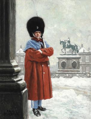 A royal guard keeps watch at Amalienborg Palace Square in winter time
