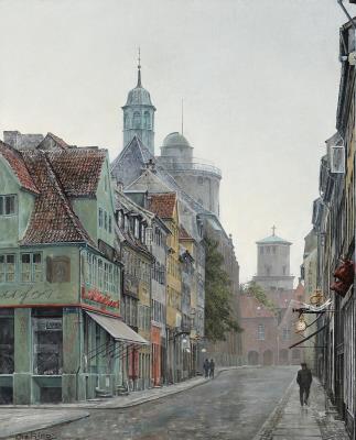 A view of a street in Copenhagen with the Round Tower in the background.