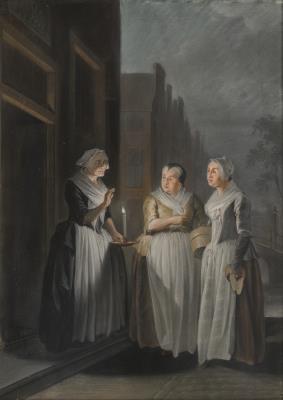 Trois femmes parlant de nuit à la lumière des bougies dans les rues d'une ville hollandaise
