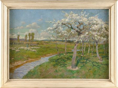 Blossoming apple trees along a stream