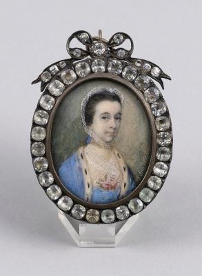 Portrait miniature of a lady wearing a white lace bonnet and blue dress
