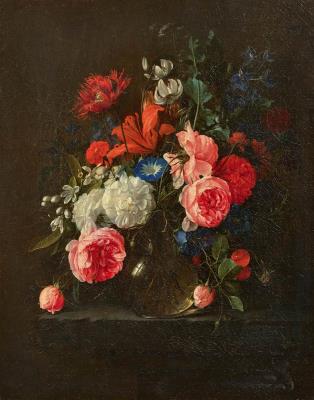 Large bouquet of flowers in a glass vase on a stone plinth