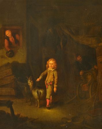 Portrait of a boy in a stable with two goats