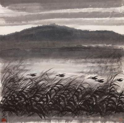 Five Geese Fly Over a Wind-Swept Reed Bed, with the Mountains Reflected in the Water in the Background