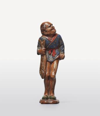 A polychrome wood netsuke of a curly-haired ashinaga