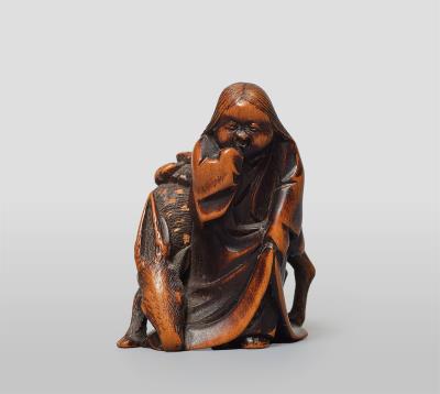 A boxwood netsuke of Uzume and a stag