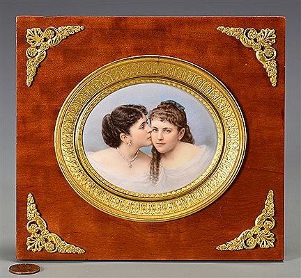 Two young women, one wearing pearl jewelry and kissing the other fondly on the cheek