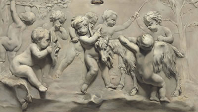 A TROMPE L’OEIL BAS-RELIEF OF PUTTI PLAYING WITH A GOAT