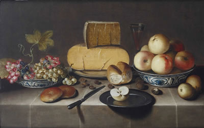 Cheese on a silver plate, red and white grapes and apples in porcelain Wanli bowls, bread rolls, a knife and a sliced apple on a plate, all on a draped table