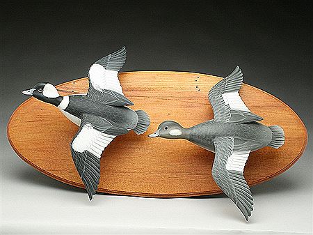 Life size carving of a pair of flying buffleheads