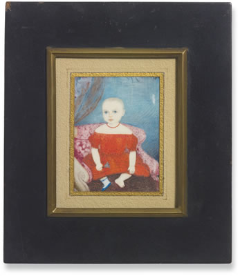 PORTRAIT OF A DEAF YOUNG CHILD IN RED DRESS HOLDING A BELL