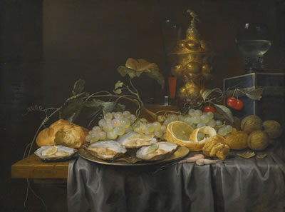 A 'PRONK' STILL LIFE OF GRAPES, CHERRIES, WALNUTS AND A PEELED LEMON, WITH OYSTERS ON A PEWTER PLATE, AND A GLASS ROEMER, WINE GLASS AND GILT GOBLET, ALL ON A DRAPED TABLE