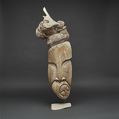 SHAMAN EMERGING FROM FACES