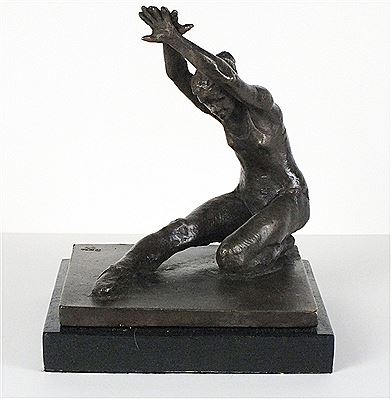 A bronze sculpture of a ballet dancer