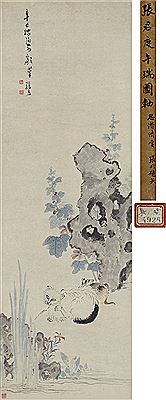 TWO CATS BESIDE A ROCK