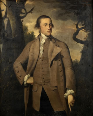 Portrait of John Owen of Penrhos, three-quarter-length, in a brown coat holding a riding crop, standing before a landscape