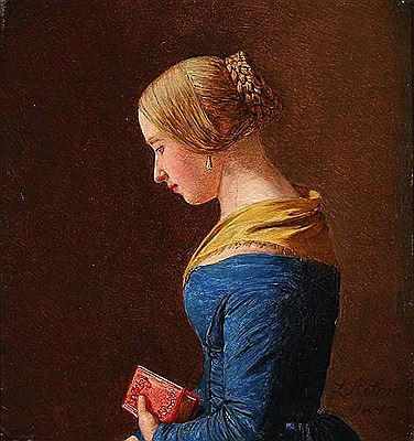 Profile portrait of a young woman in a blue dress