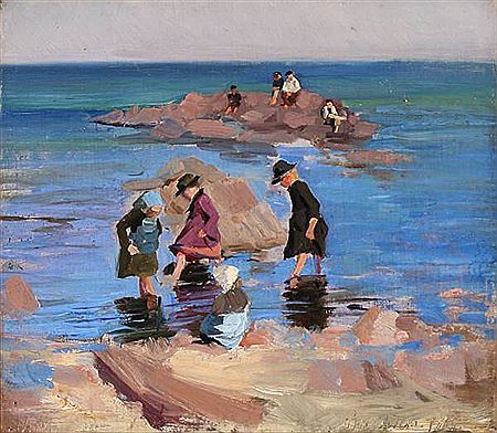 Children bathing at the rocky coast of Bornholm, Denmark.