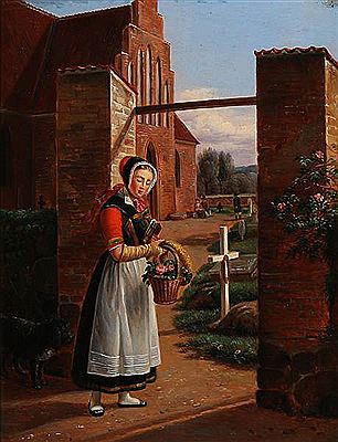 A woman in a Seeland folk costume standing near a churchyard