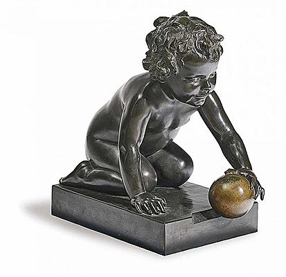 KNEELING BOY PLAYING WITH GOLDEN BALL
