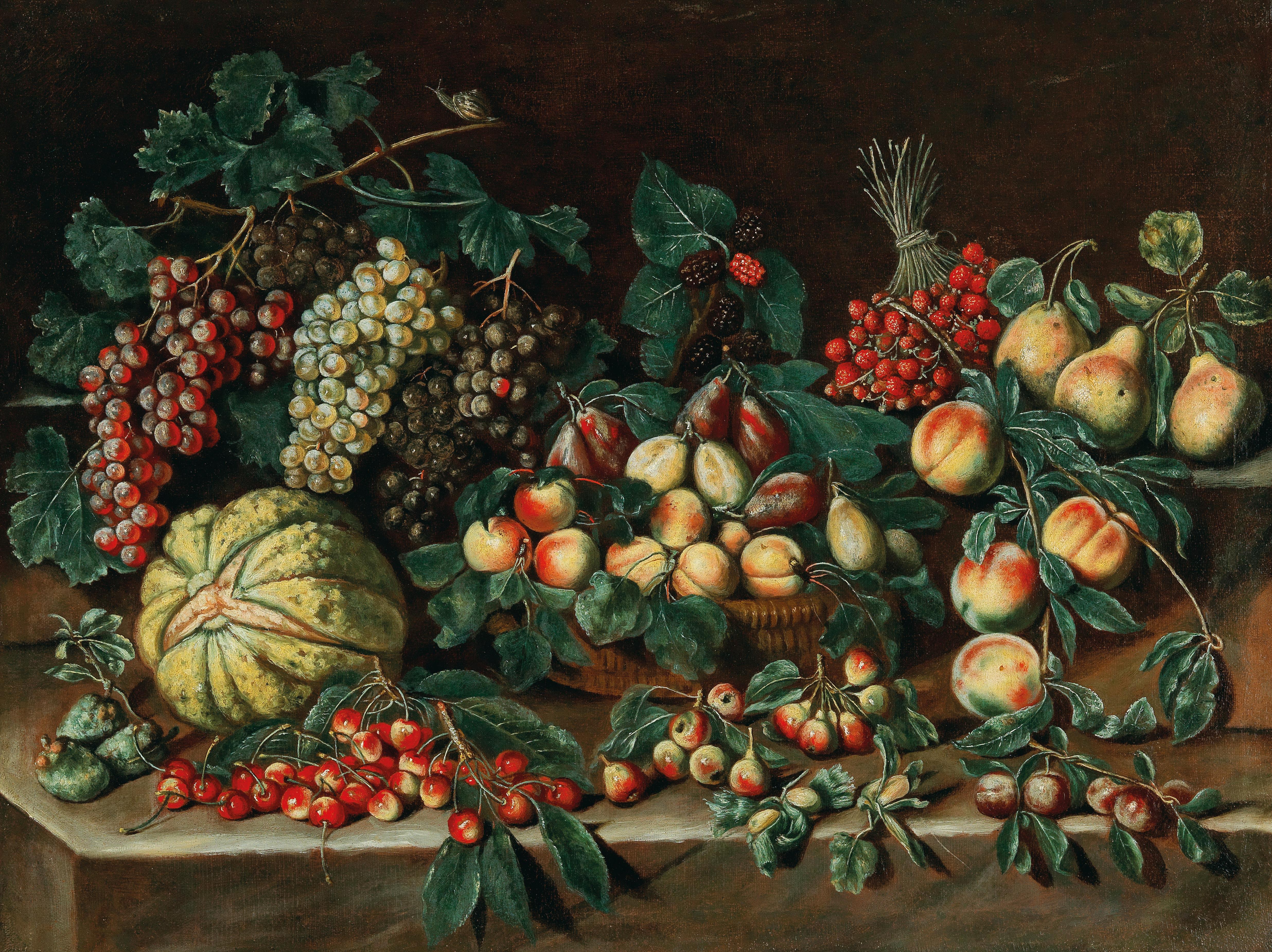 Grapes, a melon, strawberries, plums and peaches in a basket, cherries and other fruit on a stone ledge