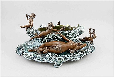 Polychrome glazed ceramic bowl in the form of billowing water with extended blades of grass on four feet with an oval shell in the center, mounted around are 5 brown patinated bronzes in wonderful shape, three boys with various attributes, a bird and a fe