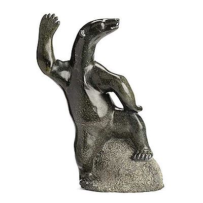 WAVING POLAR BEAR SEATED ON A ROCK