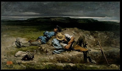 Two men reclining on rocks by ocean