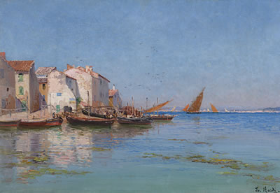 Fishing boats docked by a coastal village