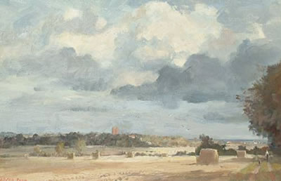 Hay bales with church beyond