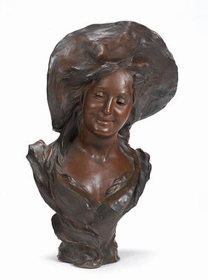 A bronze bust of a peasant girl wearing a large hat with her hair loose and a low neckline
