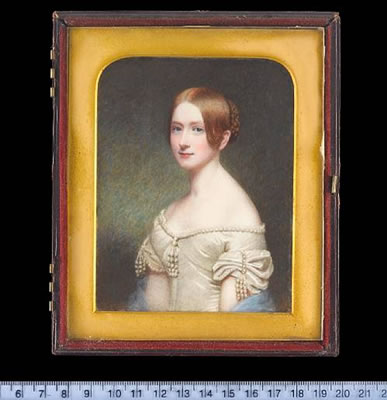 A pair of portraits of the Misses Harris, both wearing white silk dresses elaborately decorated with strands of pearls and pendent pearls, one with reddish hair in a plaited bun and blue mantle over her arms