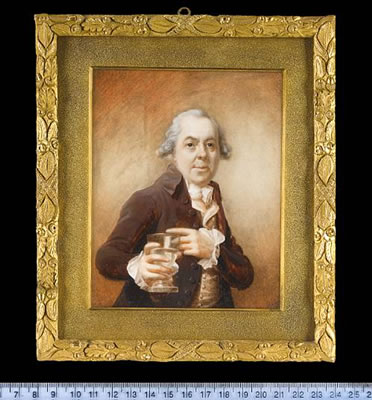 A Gentleman, half-length, wearing brown coat, cream waistcoat, frilled white shirt cuffs, cravat and powdered wig, his left hand pointing to a wine goblet of water held in his right hand