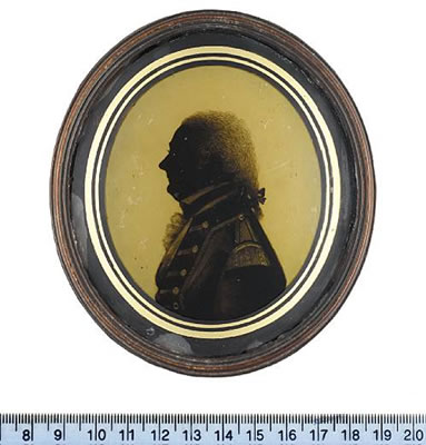A silhouette of Vice Admiral Sir Richard Grindall KCB (1750-1820), profile to the left, wearing coat with buttons and epaulette, waistcoat, frilled chemise, stock, his hair worn en queue, tied with a ribbon bow