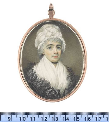 A Lady, wearing white fichu, black lace shawl, ribbon choker and white bonnet trimmed with pleated lace border tied with wide ribbon.