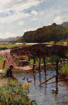 A young boy beside a stream