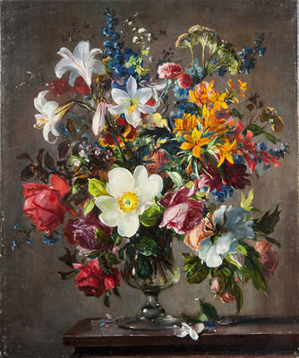 Lillies, fresias and other flowers in a glass vase