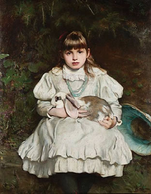 Portrait of a young girl holding a pet rabbit