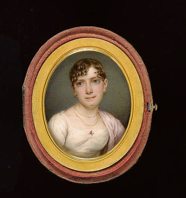 A Lady, wearing white dress adorned with ruby and pearl encrusted brooch