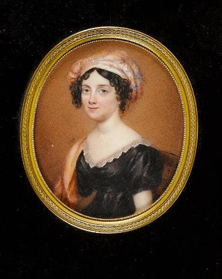 A Lady, seated, wearing black dress with white lace trim, orange cloak over her right shoulder and plaid turban in her dark hair
