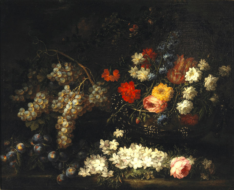 A still life with flowers in an urn and grapes and plums resting on a ledge
