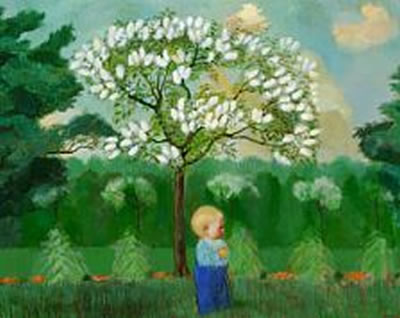 A boy standing under a tree