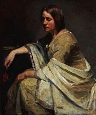 A woman in olive green dress with a light shawl.
