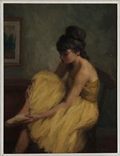 A ballet dancer putting on her shoe