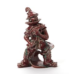 A stoneware figure group decorated with oxblood glaze