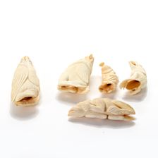 A collection of five sperm whale teeth tupilaks (5)