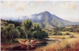 Cows Watering in a Stream with a Mountai