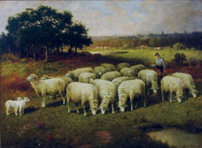 A shepherd with his sheep out in the field