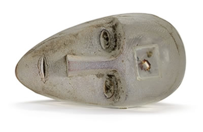 A CAST GLASS FIGURE OF A RESTING HEAD